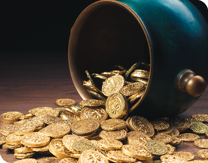 Black pot spilling gold coins.